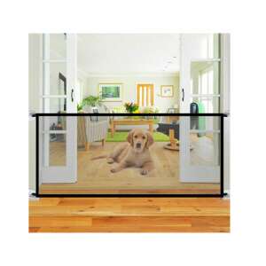 Black pet gate installed in a doorway, with a dog lying in front of it - Pet Care
