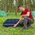 Man inflating Bestway single air mattress at campsite
