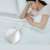 Deerma CM800 handheld vacuum cleaner on a bed, with a woman sleeping