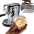 De'Longhi Dedica Arte EC950.M espresso machine with milk being poured into a cappuccino.