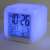 White digital alarm clock with color changing LED light, shows time, date, day of the week, and temperature