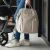 BabyOno Modern Style beige diaper bag backpack hanging on stroller