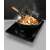 Gorenje ICE2000SP portable induction cooktop in use, cooking stir fry