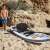 Man inflating HYDRO FORCE White Cap Convertible SUP, inflatable paddle board, pump, beach, sand, summer, outdoor