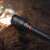 NEBO 12K waterproof flashlight on wet surface