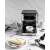 Gorenje ESCM15DBK Espresso Coffee Maker, black and stainless steel, on a table with coffee beans, a cup, and a cheesecake