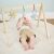 Baby reaching for toys on Nattou Felix and Leo wooden gym