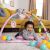 Happy baby playing on Bright Starts 5-in-1 play gym