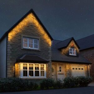 Instalație de Crăciun Flippy, tip țurțuri, decorând exteriorul unei case pe timp de noapte - Ghirlande luminoase