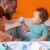Father and baby playing in Bright Starts Tropical ball pit