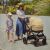 Petite&Mars Trails 2in1 Stroller Heritage Bee with mother and child on a walk