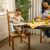 Child eating at table in Ingenuity Baby Base 2-in-1 Booster Seat on chair