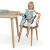 Toddler sitting in Ingenuity Baby Base 2-in-1 Booster Seat on chair at table