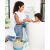 Mother bathing child, Skip Hop Moby Stowaway bath toy organizer bucket in foreground
