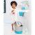 Toddler with towel holding bath toy, Skip Hop Moby Stowaway toy organizer bucket nearby