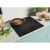 Candy CTP644MCBB/1 Induction Cooktop in kitchen setting with food