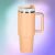 Pink insulated mug with handle and straw on blurred background