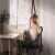 Woman relaxing in Pepita black macrame hanging chair