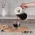 Pouring coffee from Berlinger Haus Sahara French Press into glass cup