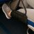 Lógó travel footrest in use on airplane, improving comfort