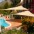 GardenLine beige triangle shade sail over patio and pool