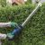 Using Scheppach C-HT570-X cordless hedge trimmer to trim a hedge