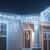 Pepita cold white icicle lights decorating a porch