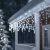 Close-up of Pepita icicle lights on a house eave, cold white LEDs
