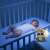 Chicco Cloudy Music on the Go raccoon musical toy with projector used as night light in baby crib