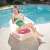 Woman relaxing on Bestway SMA 037 inflatable beach chair by the pool