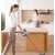 Woman using the Dreame T20 cordless stick vacuum cleaner in a kitchen