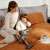 Woman using Dreame T30 cordless stick vacuum cleaner, grey, on bed with child and cat