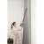 Woman using Dreame T30 cordless stick vacuum cleaner, grey, to clean curtains
