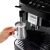 DeLonghi Magnifica Evo automatic coffee machine in use, frothing milk