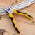 Deli Tools EDL2007 combination pliers in use, cutting wires