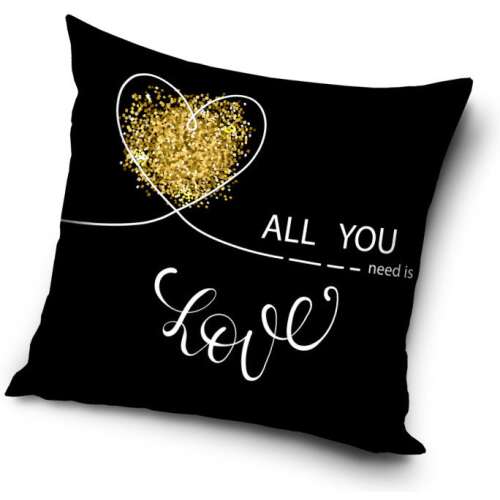 Black decorative pillow with gold glitter heart and 'All you need is love' text