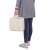 Person carrying Springos beige shade sail in carry bag