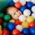 Happy child playing with Euro-Matic 6cm colorful plastic balls in a ball pit