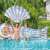 People with Bestway inflatable seashell, mermaid tail, and swim ring in pool.