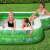 Bestway Tropical Paradise inflatable family pool with built-in seat and cup holder, kids playing in the pool