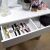Open Drawer of White Vanity Table with Watch Collection