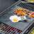 Non-stick heat-resistant baking sheet for oven and grill, fried egg and vegetables on the sheet on a grill
