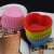 Set of 12 heart shaped silicone muffin cups, in various colors, stacked on top of each other