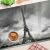 Eiffel-torony témájú üveg vágódeszka sütikkel és fűszernövényekkel a pulton.