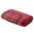 Red plaid picnic blanket with waterproof backing, rolled up and showing the handle