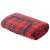 Red plaid picnic blanket with waterproof backing, rolled up and showing the handle