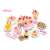 Pink pretend play cake set with 75 pieces, including cake slices, fruit, candles, and utensils