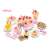 Pink pretend play cake set with 75 pieces, including cake slices, fruit, candles, and utensils