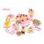 Pink pretend play cake set with 75 pieces, including cake slices, fruit, candles, and utensils