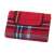 Red and blue plaid picnic blanket with waterproof backing, folded, showing the handle and velcro closure